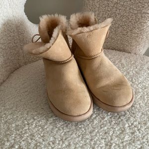 Size 7 Mini Uggs in a peachy nude with side buttons